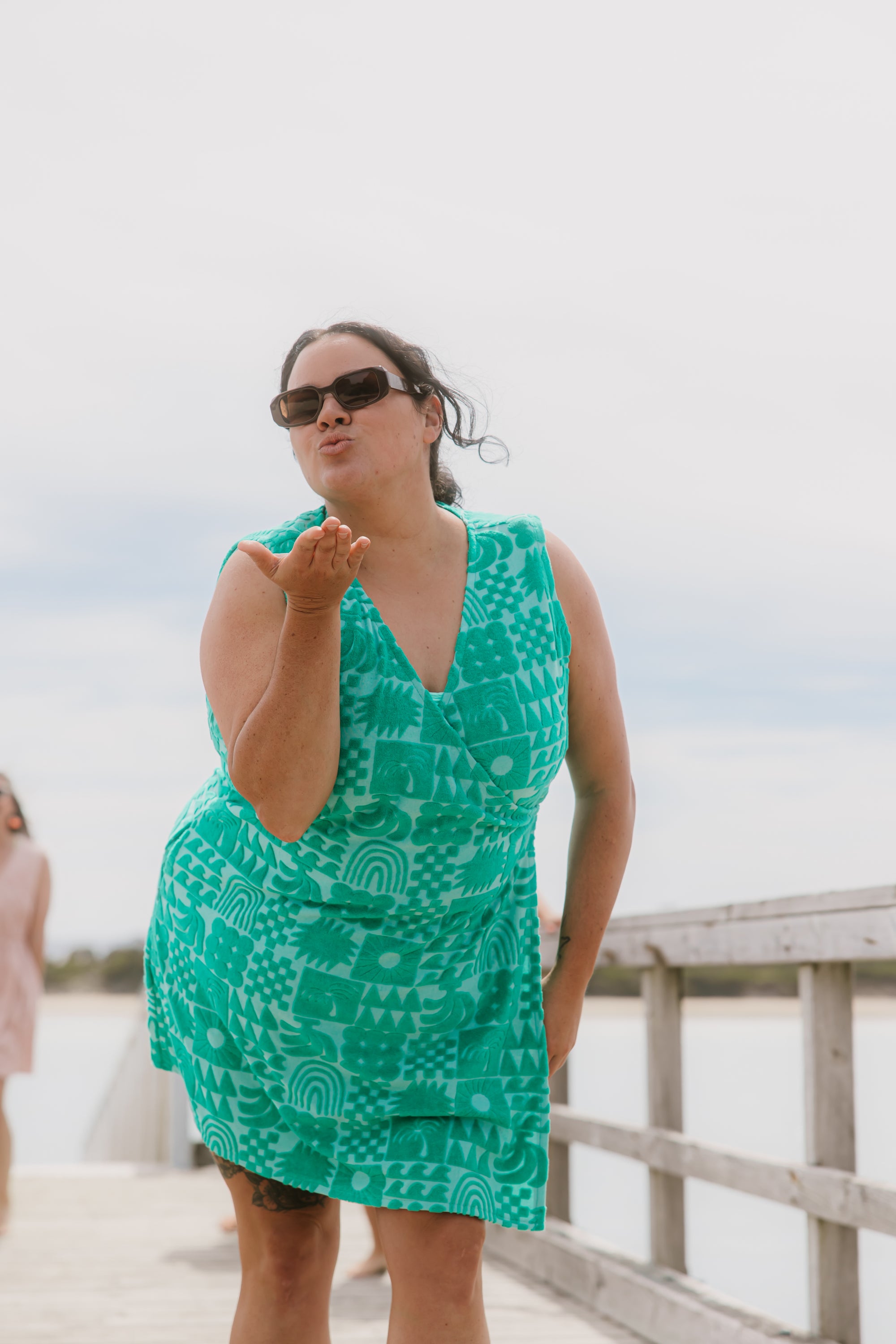 Woman wearing Sprout green terry wrap dress at the beach