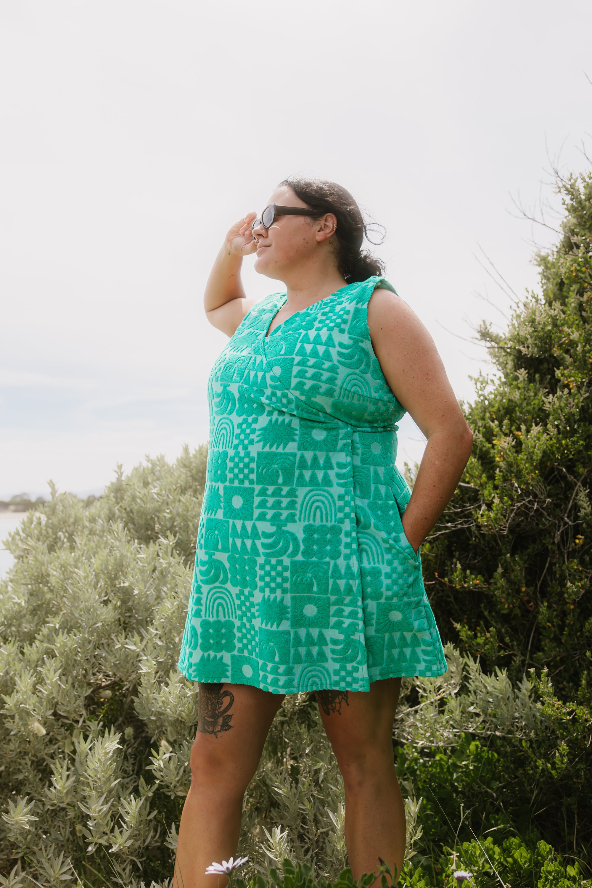 Woman wearing Sprout green terry wrap dress at the beach