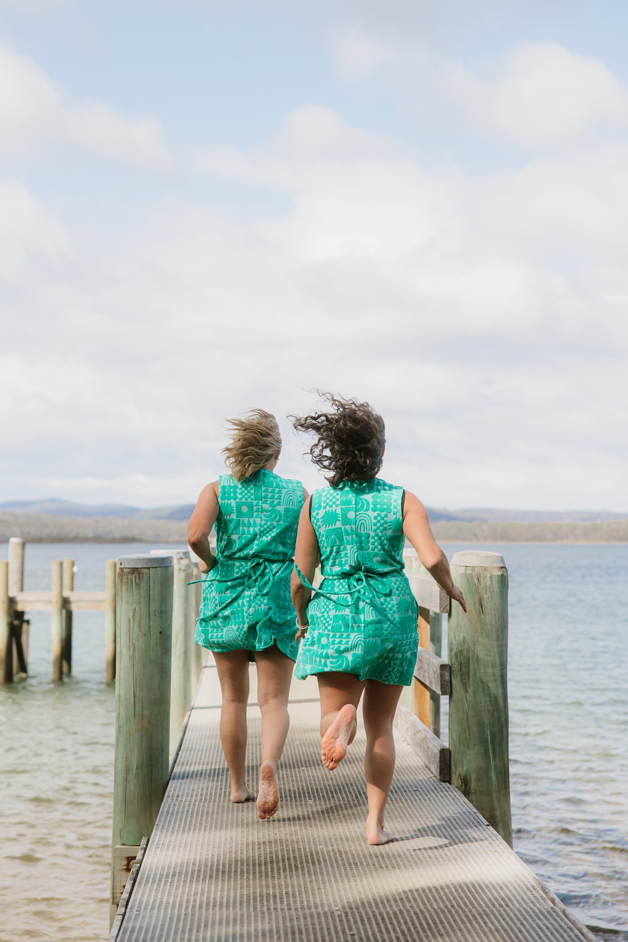 Back view of two women wearing sprout green terry wrap dress with ties