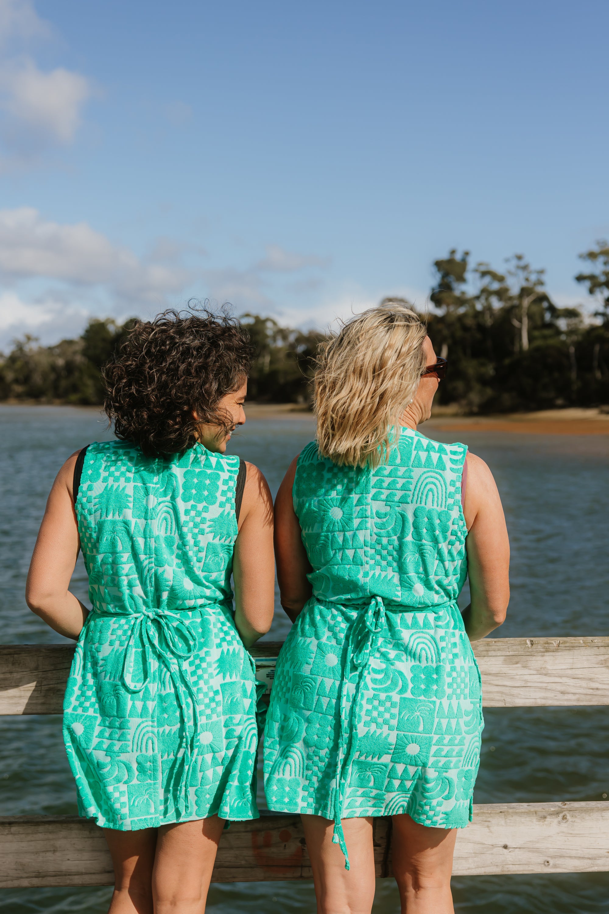 Back view of two women wearing sprout green terry wrap dress with ties