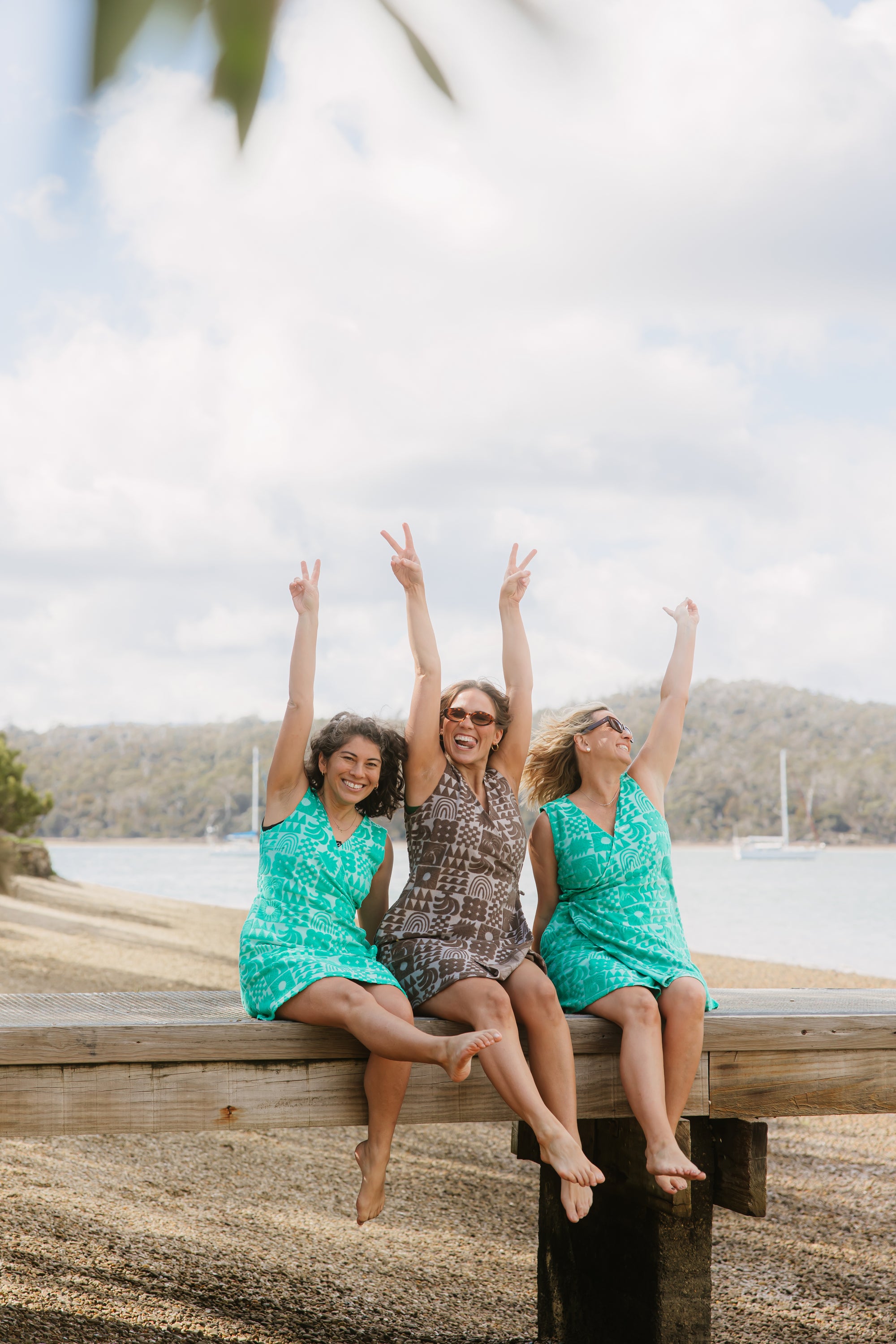 Three women wearing Sprout green and Cocoa brown terry wrap dress at the beach
