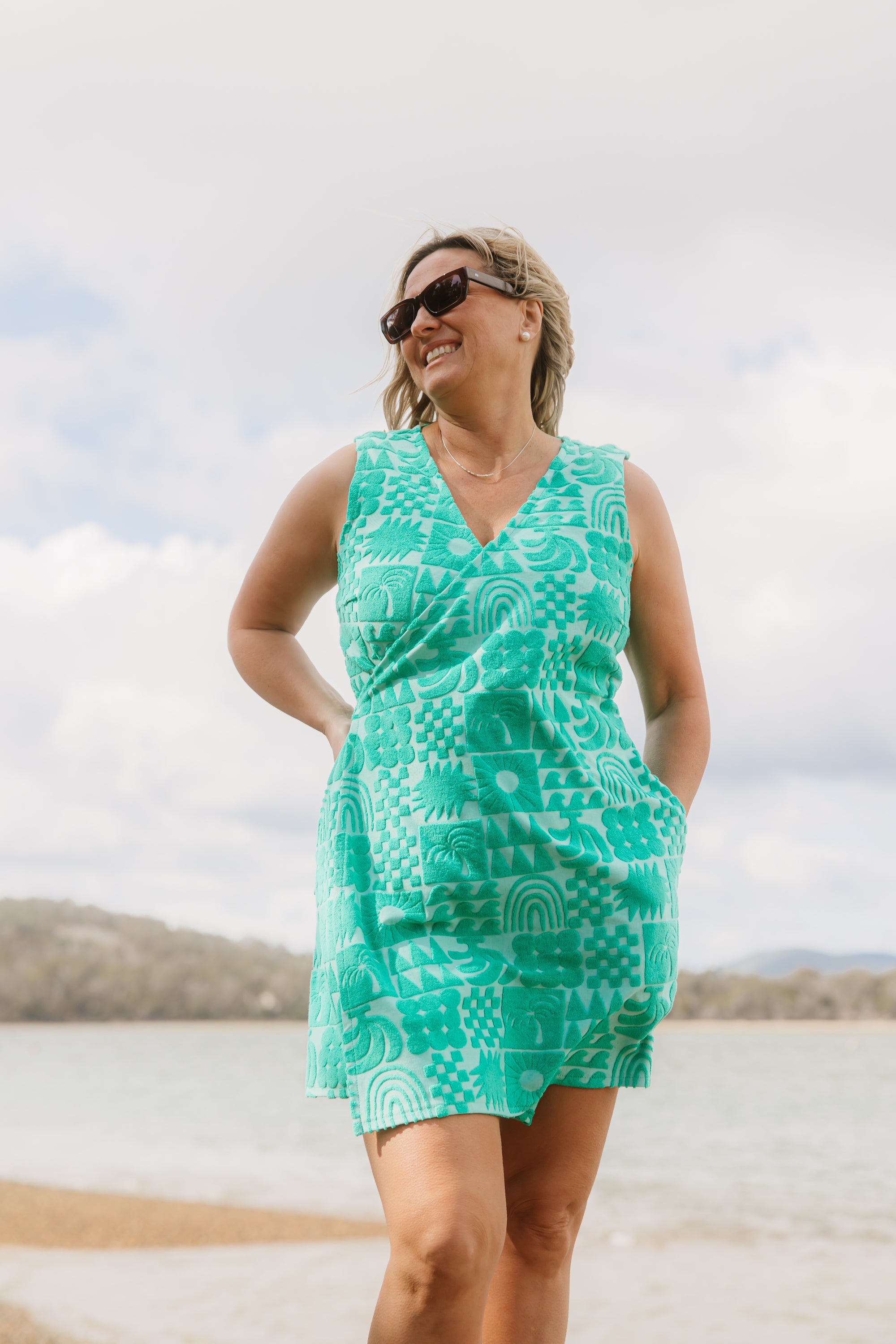 Woman wearing Sprout green terry wrap dress at the beach